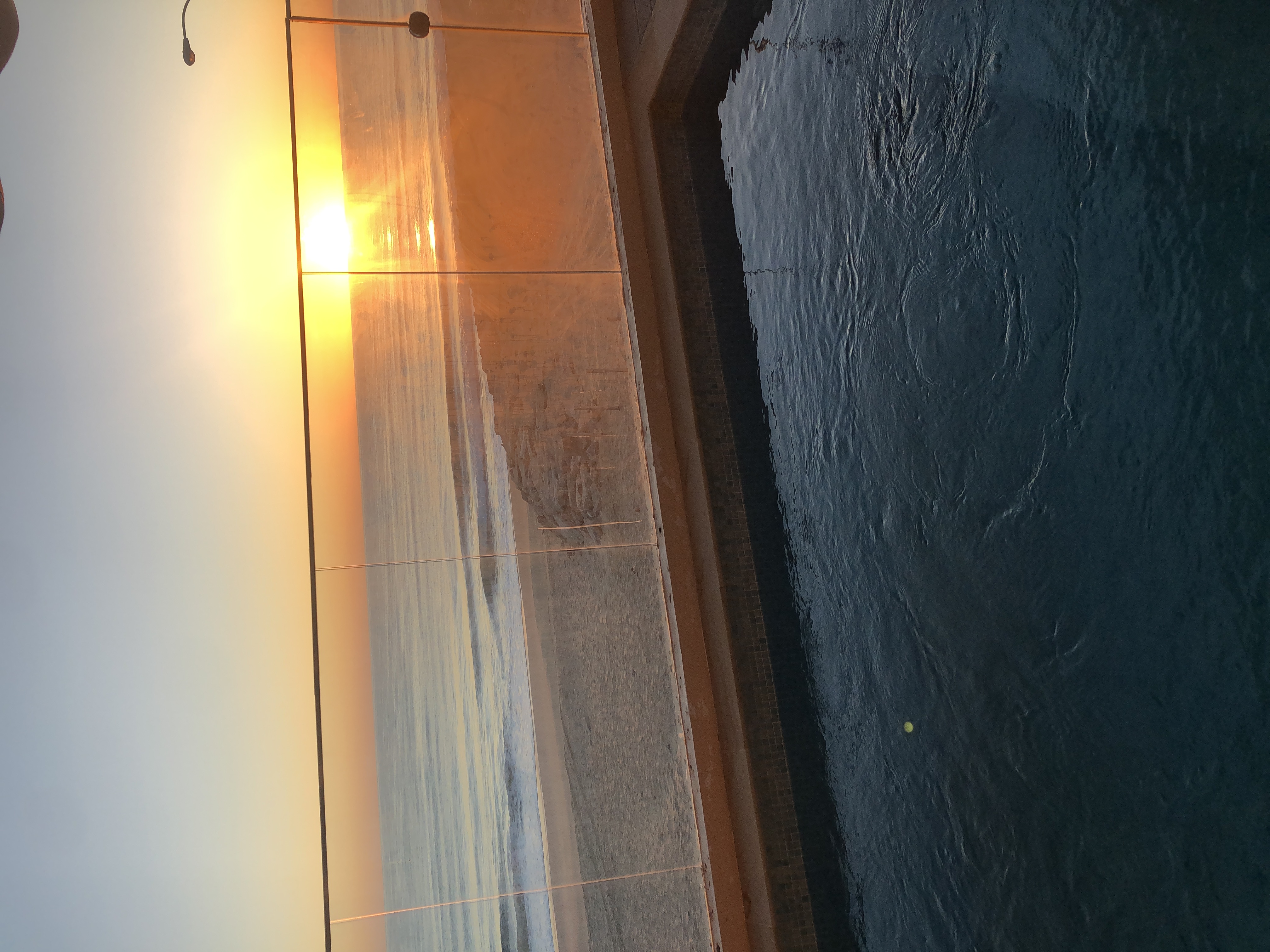 Pool at golden hour overlooking the sea